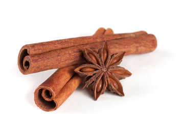 two cinnamon sticks with star anise isolated on white background