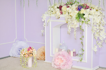 Fireplace decorated with flowers.