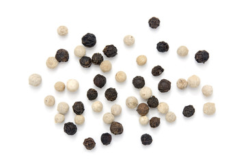 Black and white peppercorns on white background