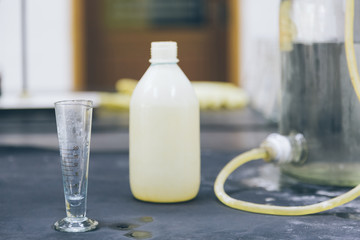 detail shot of beakers and equipment on table in factory laboratory.