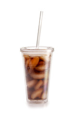 Cola in plastic glass with ice and straw on white