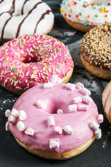 Freshly baked donuts with a filling on a black background