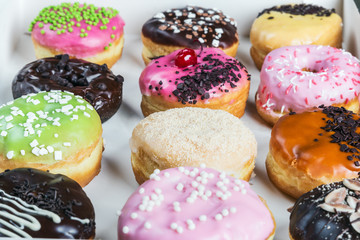 glazed donuts with different fillings in the box