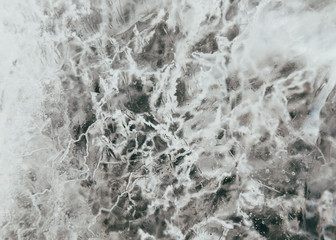 Macro shot of melting ice structures with cracks
