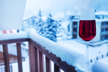 Glass of wine on balcony balustrade in hotel suite