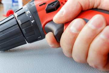 The screwdriver in the master's hand closeup