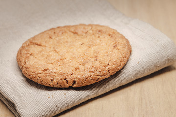 Pastry biscuits on linen napkin on wooden table