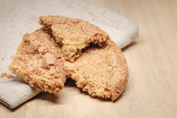 Pastry biscuits on linen napkin on wooden table