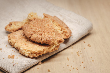 Pastry biscuits on linen napkin on wooden table