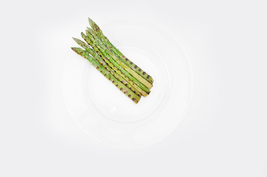 Grilled Asparagus On Glass Plate, On A White Background