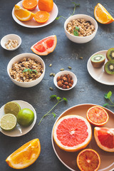 Colorful fresh fruit on dark table. Orange, tangerine, lime, kiwi, grapefruit. Summer fruit