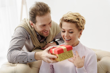 Caring man giving present to his wife