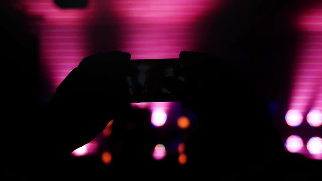 Recording and taking pictures with mobile phone during rock concert and party. 3840x2160