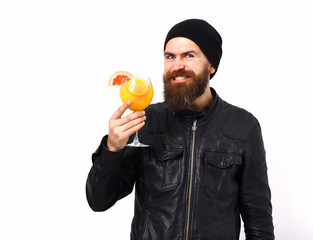 Brutal caucasian hipster holding alcoholic beverage or fresh cocktail