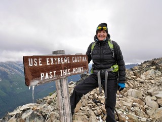 Obraz premium Smiling woman in her 40s on mountain top looking fit and happy. Frosty Mountain in Manning Park near Hope, Vancouver. British Columbia. Canada.