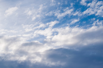Fototapeta premium The backdrop of blue winter sky with dark clouds at sunrise in the early morning