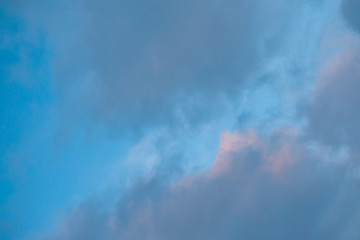 The backdrop of blue winter sky with dark clouds at sunrise in the early morning