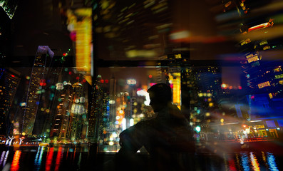 Long exposure shot of man sitting next to window. Multi exposure.