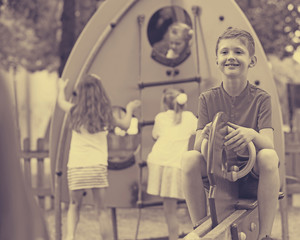 Obraz na płótnie Canvas cheerful boy on children's playground.