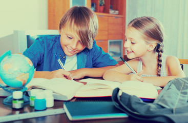Children studying with books indoors.