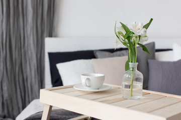 Bedroom interior with small table on bed