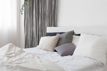 Bed with white and grey linens