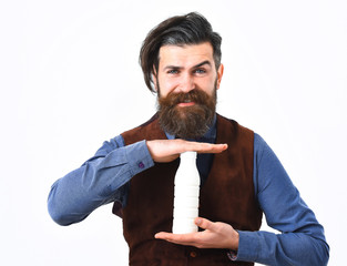 bearded man holding bottle of kefir with happy face