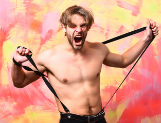Caucasian bearded sexy macho man in pants with suspenders