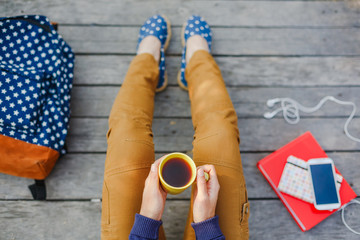 Lifestyle, vacation, education and people concept. Young hipster girl have a tea time outdoor