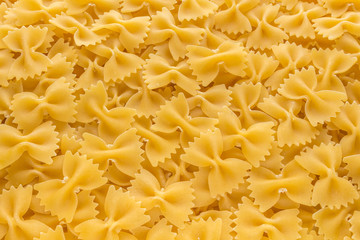 Food background made of raw Farfalle noodles