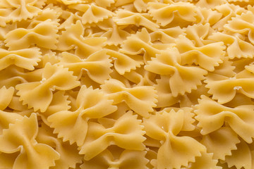 Food background made of raw Farfalle noodles
