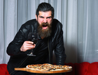 Angry bearded man shouting over tasty pizza