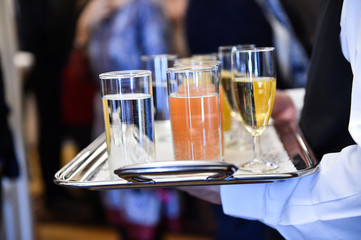 Waiter holding a tray with beverages during cocktail party