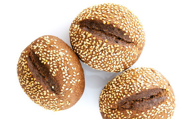 Black bread with sesame seeds on white background