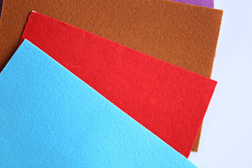 Sheets of variegated felt on an adhesive basis On a light background. 
