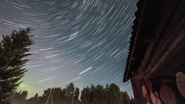 Star Trails Night Sky Cosmos Galaxy Time-lapse over old village. Amazing high resolution night lapse at Tudulinna, Estonia. Nature landscape.