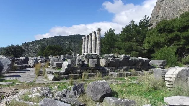 General temple view with columns around of Priene Ancient City in Aydın, Turkey, on bright blue sky background.