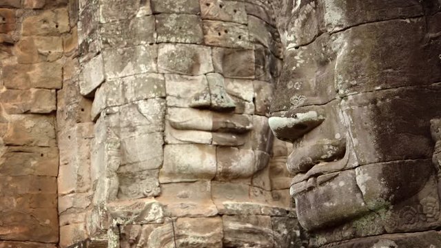 Ancient, Hand-carved stone faces at Bayon Temple in Cambodia