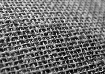 Black and white hessian cloth sack texture with blur effect.