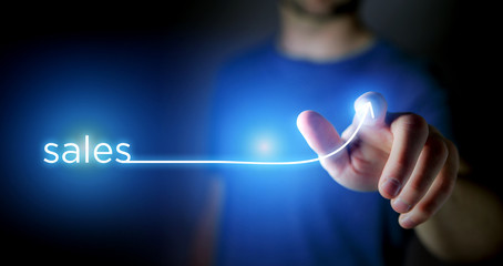 Concept of man touching arrow going up on a technology interface - Business success concept