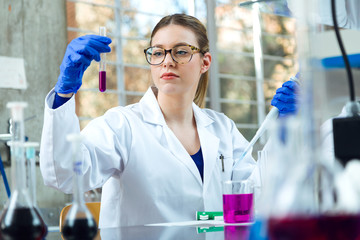 Fototapeta premium Portrait of concentrated scientist making experiment in laboratory.