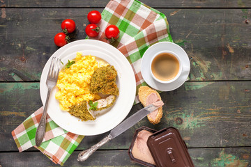 Breakfast - an omelet, chicken fillet in a green breading and coffee on a table. Selective focus. Top view. Copy space.
