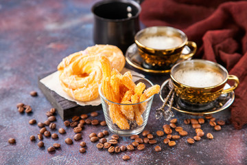 Eclairs and coffee on a table. Selective focus. Copy space