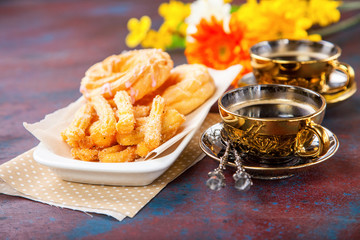 Eclairs and coffee on a table. Selective focus.