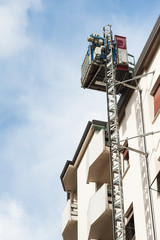 Elevator construction attached to the wall.