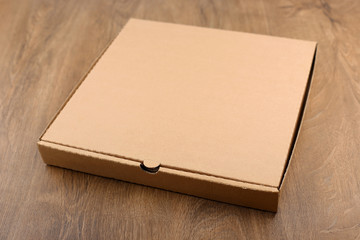 Cardboard box on wood table. Carton box pizza package.