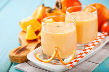 Orange persimmon smoothie with granola  and fruits. Selective focus. Copy space