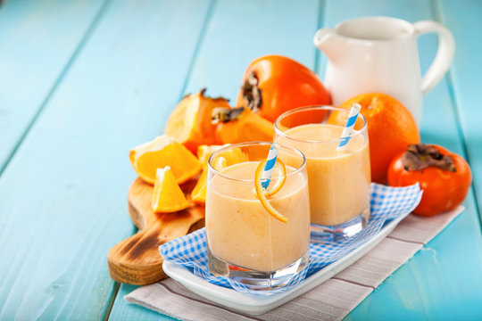 Orange persimmon smoothie with granola  and fruits. Selective focus. Copy space