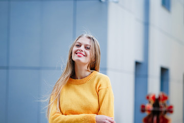 Fototapeta premium Fashionable long blond hair young woman in the city