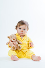 Portrait of a smiling child with a toy bear, isolated on a white background